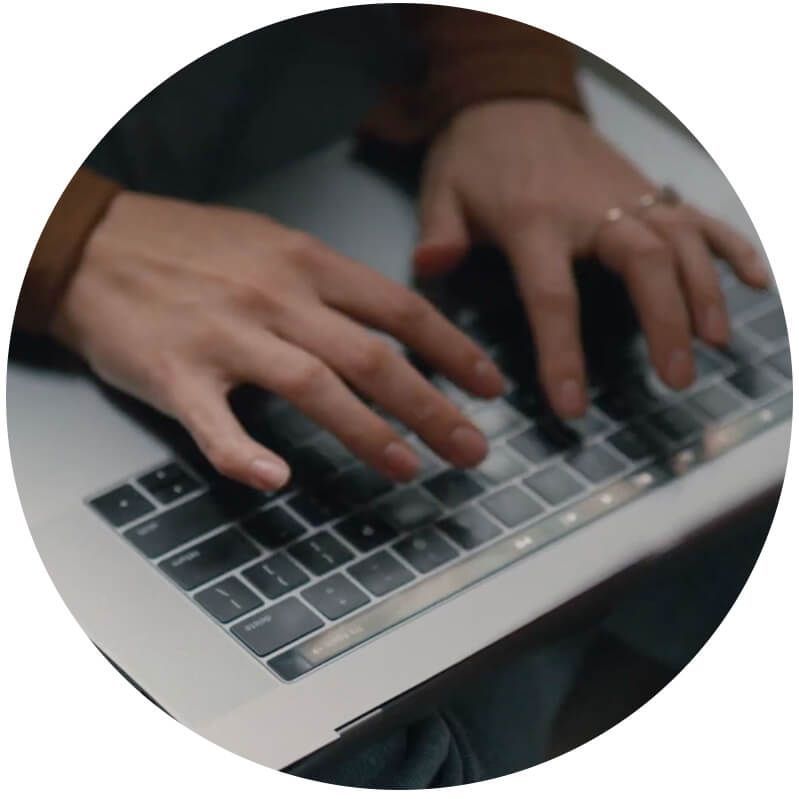 Person typing on a MacBook keyboard